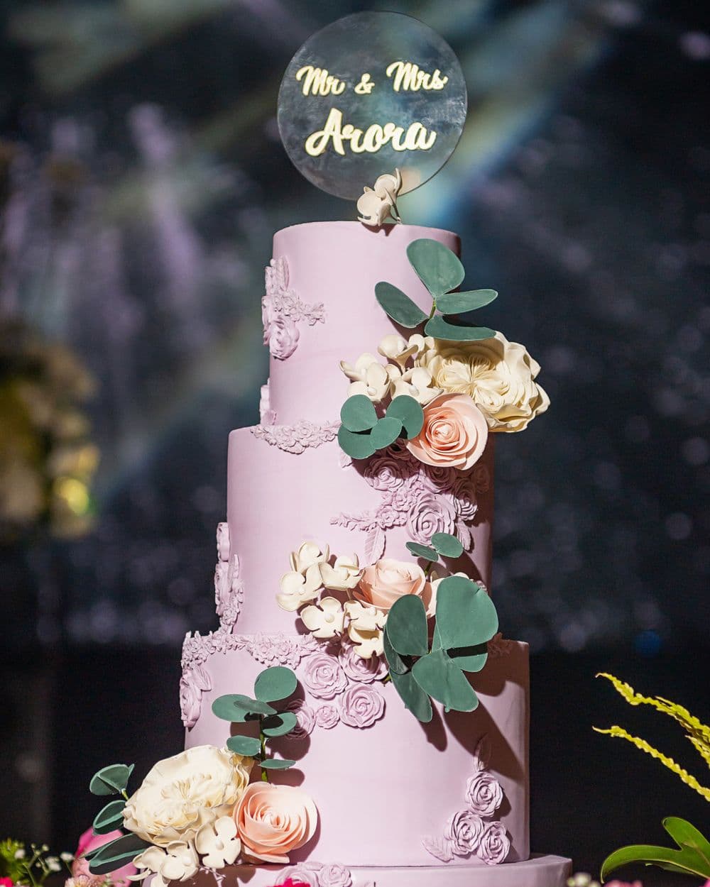 Blush tiered cake dressed with handmade sugar roses and eucalyptus
