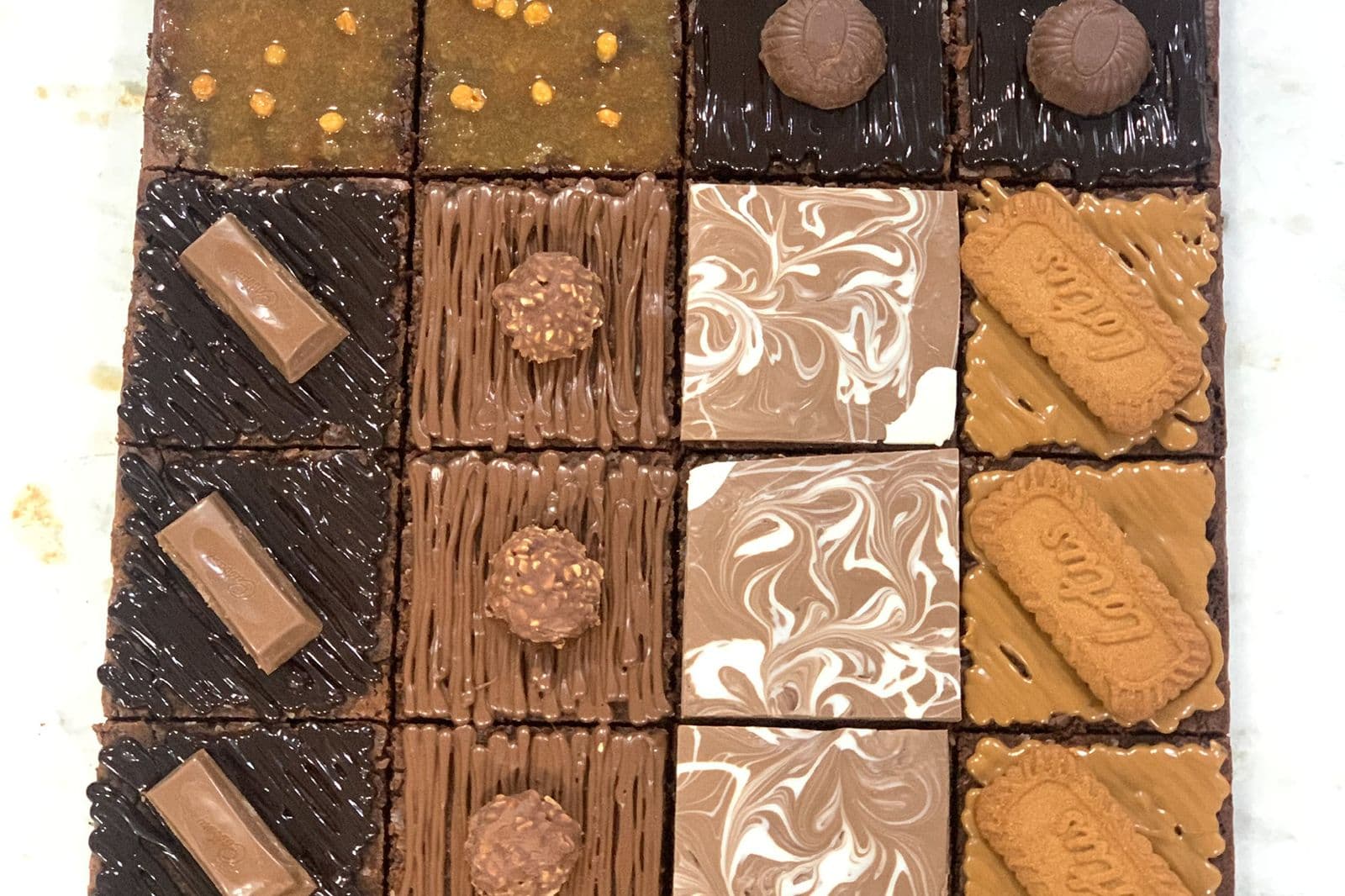 Assorted brownies arranged in a grid, each a different flavour
